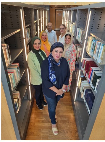 The Quality Team at Bibliotheca Alexandrina 6 staff members pictured in the book stacks.
