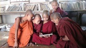 Buddhist Monks reading from a tablet at Tharsi Quarter Library